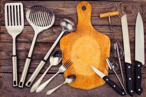 kitchen utensils on wooden background. Toned image.