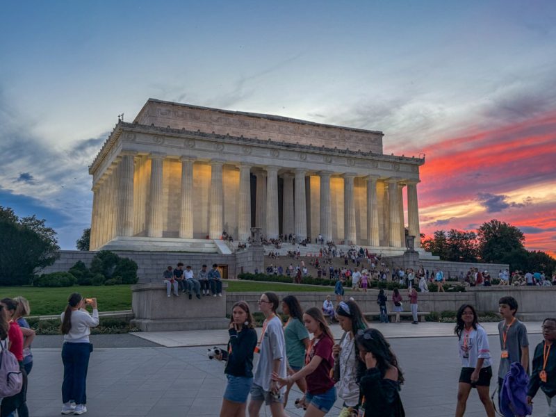 Visitors on the Lincoln Memorial steps at sunset
