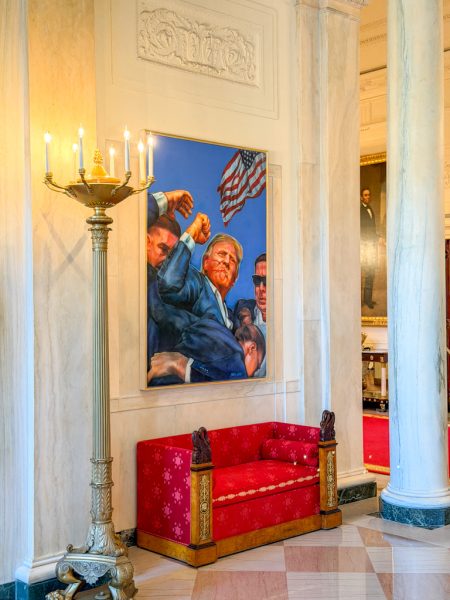 A red sofa and presidential portrait inside the White House